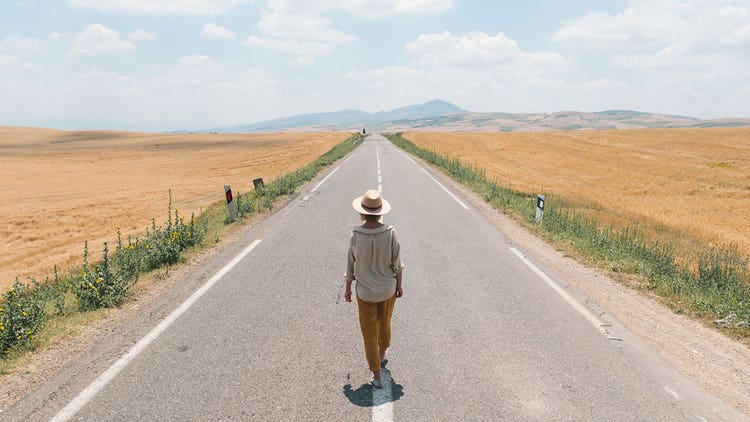 2-woman-walking-down-a-deserted-road
