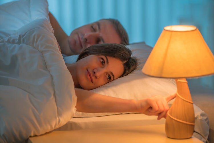 turning-off-bedside-table-lamp