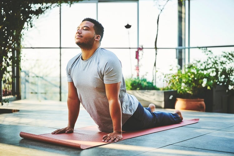 Young man practicing Upward Facing Dog Pose