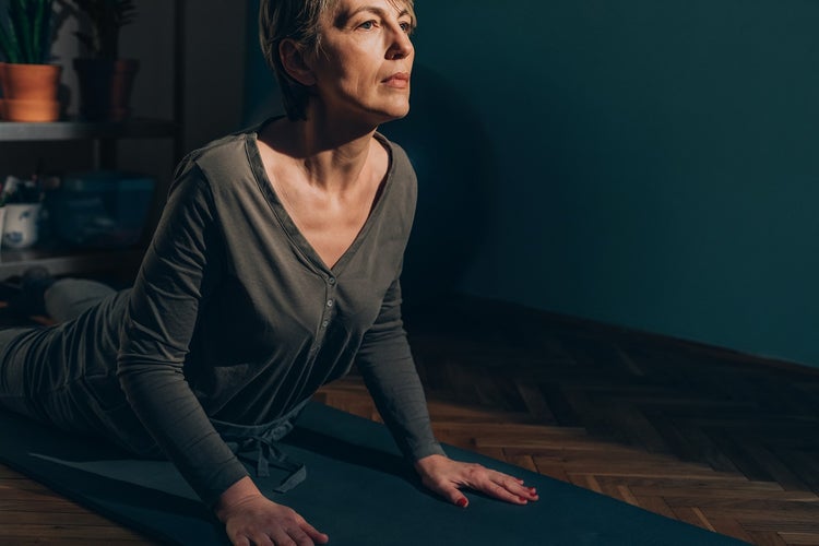 Woman doing bedtime stretch upward facing dog