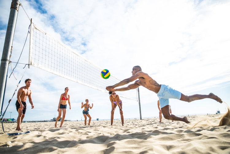 Friends play beach volley